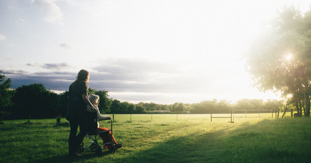 caregiver and friend watching sunset